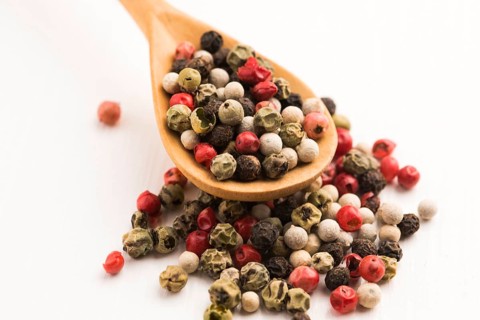 Mixed green, red, white and black peppercorns