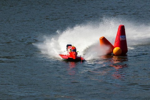 PESO DA REGUA, PORTUGAL - SEPTEMBER 15, 2024: Red Powerboat Makes Sharp Turn with Splashes of Water