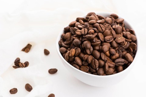 Bowl of caffee beans on a white background
