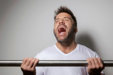 An image of a bearded bodybuilding man