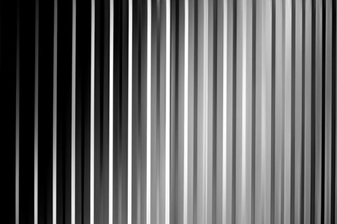 An abstract black, white and grey striped surface with shadows and vignettes