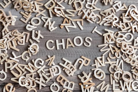 An image of some wooden letters and the word chaos