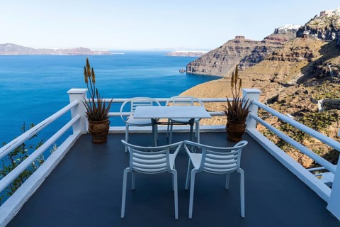 Table and armchair, viewpoint on the crater rim, Fira, Santorini Island, Cyclades, Greece