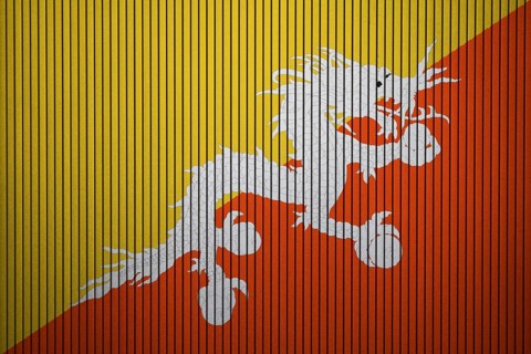 Bhutan flag painted on the cracked grunge concrete wall