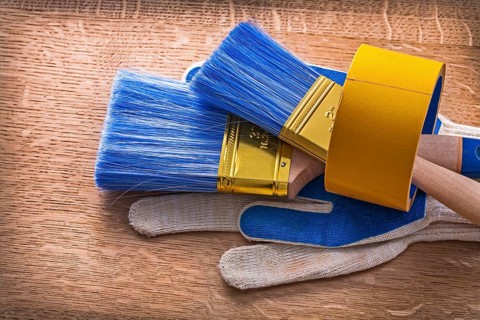 Set of protective gloves with paint brushes in duct tape maintenance concept
