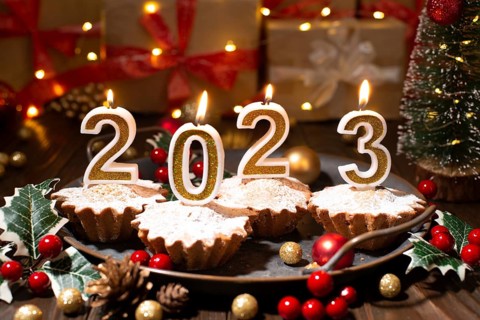 Food tray with cupcakes new year candles and christmas decorations