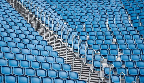 Blue plastic empty stadium or stage chairs in a row