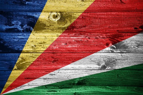 Seychelles flag on wooden planks background wood flag