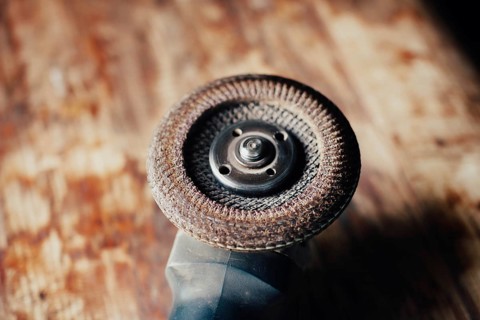 Detailed view of an angle grinder on a wooden surface