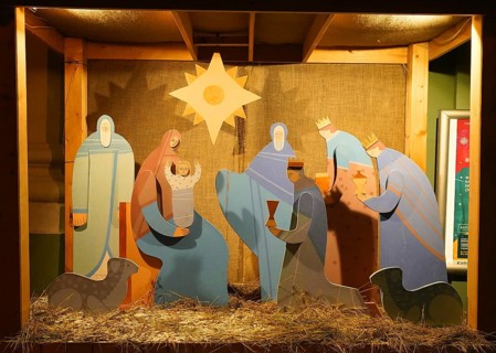 Snowy winter morning and New Year's electrical decorations in the city center, Nativity scene near