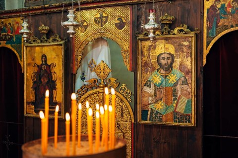 The interior of the church. Icons, chandelier, candles in a small Christian Orthodox church in