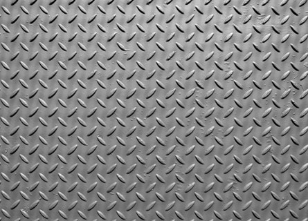 Grey steel metal plate with painted surface and industrial safety diamond pattern texture