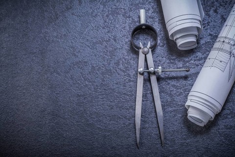 Construction drawings pair of compasses on black background maintenance concept