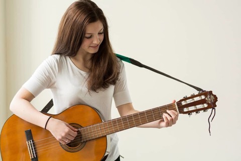 Teenager plays with a guitar - copy space