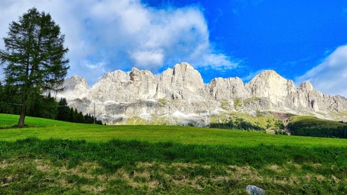 Val di Fassa with a view of the Dolomites (Catinaccio) and blue sky
