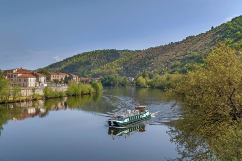 View of Lot river with ship in Cahors, France