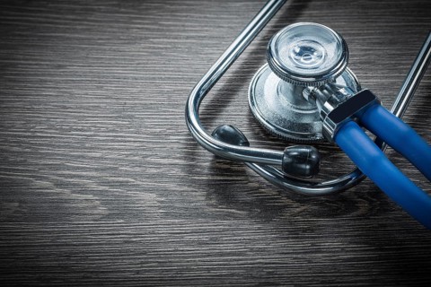 Stethoscope on vintage wooden board