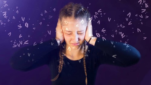 Teenage girl dressed casual with pigtails, being attacked by social media, creating emotional