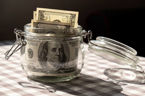 Dollar banknote saving money in glass jar. Consumption and economy Collecting money. Tips.