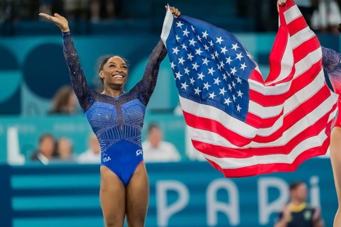 Simone Biles (USA) of the United States celebrates with the fans after winning the Artistic