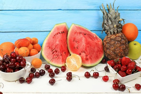 Summer berries and fruits on wooden background, healthy natural food concept, breakfast with