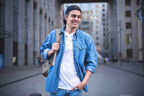 Background on the street while waiting his colleagues. Businessman wearing casual white shirt and