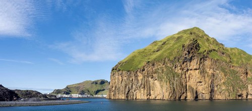 Harbour entrance to the harbour town of Heimaey, steep rocky cliffs, panoramic view, Westman