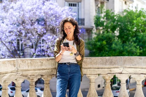 Urban woman engaged in texting on her smartphone