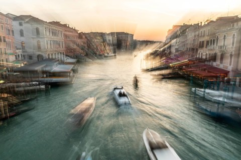 Evening light at sunset, view over the Grand Canal, gondola and boats, from the Rialto Bridge, zoom