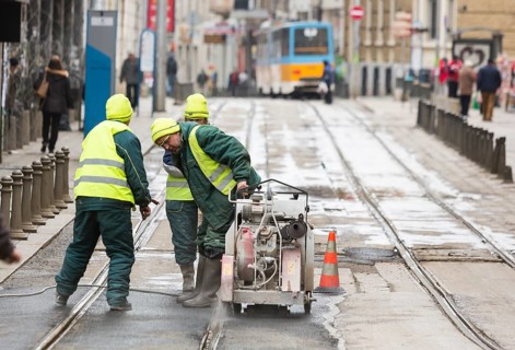 Sofia, Bulgaria - February 27, 2016: Transportation workers are cutting the asphalt at the tram