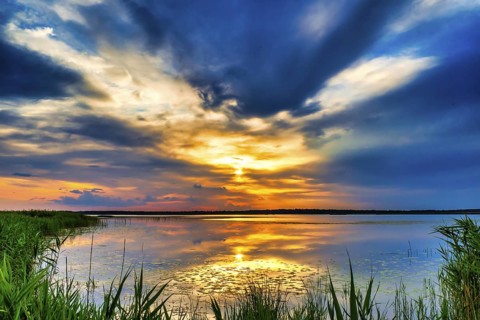 A Beautiful Golden Sunset on The Lake. Amazing Sunset Reflection in The Water