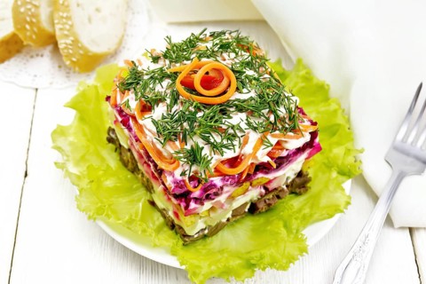 Puff salad with beef, boiled potatoes and beets, pears, spicy Korean carrots, seasoned with