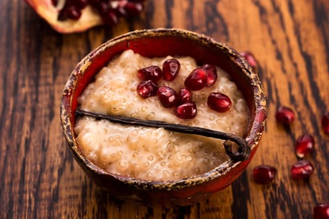 A bowl of tapioca pudding with vanilla and pomegranate