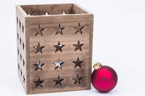 The photo shows a lantern with a red Christmas bauble