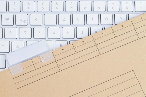 The photo shows a white keyboard with a briefcase