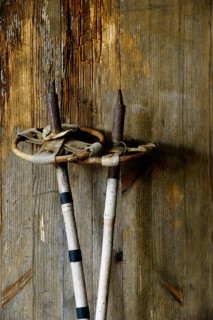 Old vintage ski poles on a wooden background