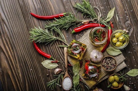 Flat lay food background made of oils condiments and spices on kitchen table. Cooking concept