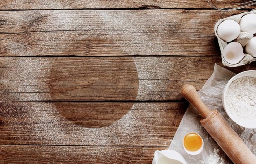 Christmas baking ingredients, kitchen utensils on old wooden background. Cooking dough, preparing