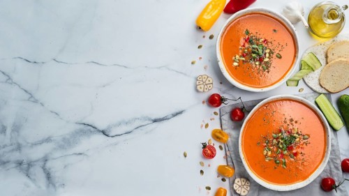 Gaspacho soup on white marble tabletop. Two bowls of traditional spanish cold soup puree gaspacho