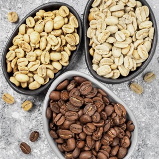 Top view of white, green and brown coffee bean in plate
