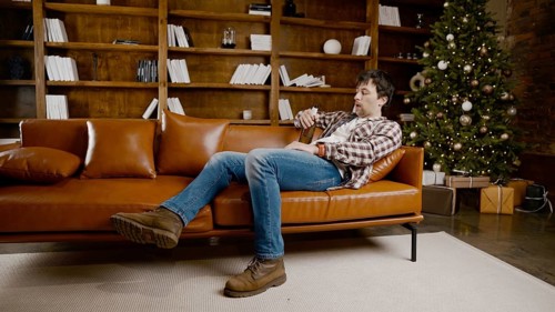 Depressed young man drinking alcohol at home. Unemployed male, drunk and continues drink wine