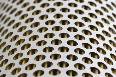 Detail of a tractor oil filter creates an industrial textured background