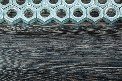 Stainless nuts on wooden board