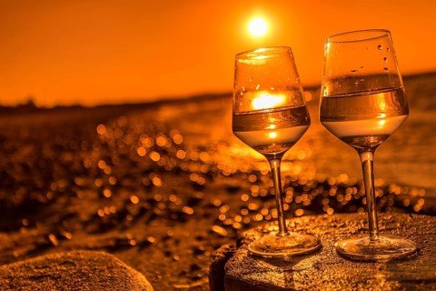 Wine on the baltic sea beach at sunset