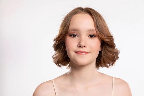 A captivating portrait of a stunning young woman with wavy hair, showcasing her confidence and