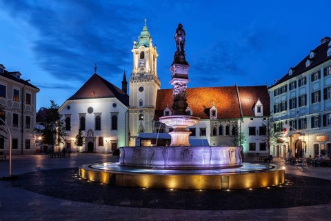 City of Bratislava at night in Slovakia, Roland Fountain, Old Town Hall building and Jesuit Church