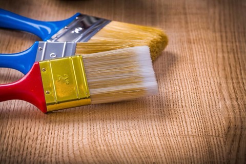 Very close up view on stack of three paint brushes