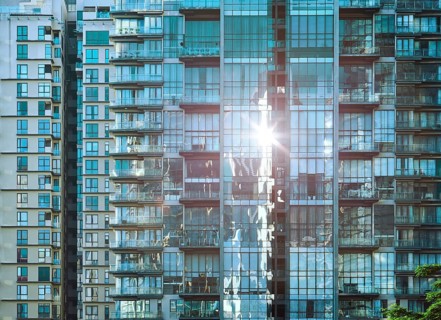 Urban abstract close up view of multiple steel and glass windows facade office building