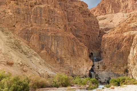 Cascading waterfall in a narrow gorge. The Judean Desert around the Dead Sea after heavy winter