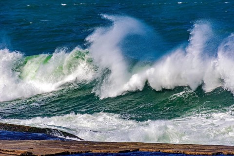 Big, dangerous waves during tropical storm in the green and blue waters of Rio de Janeiro, Brazil